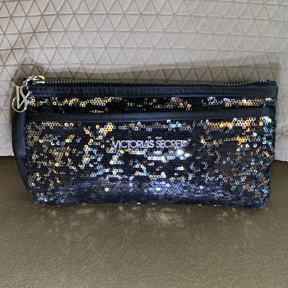 Victoria’s Secret black sequin clutch bag 
Approximately 5” x 9”
Zip closures